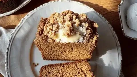 Brown butter pumpkin streusel bread on a wooden table with fall decorations