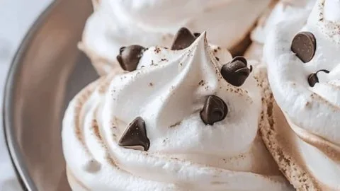 Melt-in-your-mouth chocolate chip meringue cookies on a plate
