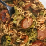 Delicious Chicken Sausage and Broccoli Orzo Skillet in a cast iron pan