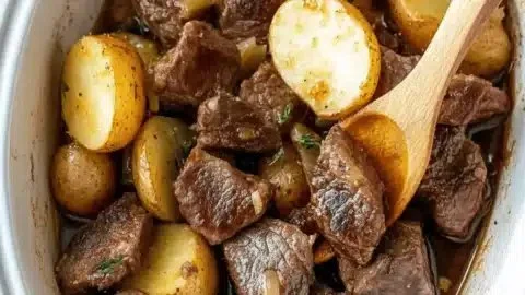Savory slow cooker garlic butter steak bites with potatoes recipe