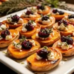 sweet potato rounds with goat cheese and cranberry balsamic glaze on a white plate