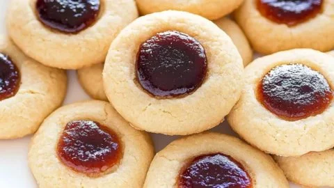 Delicious thumbprint cookies filled with jam, perfect for holiday treats.
