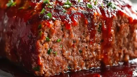Savory smoked meatloaf glazed with sweet sauce, ready to serve for family dinners.