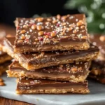 Delicious homemade Ritz cracker toffee topped with chocolate and nuts